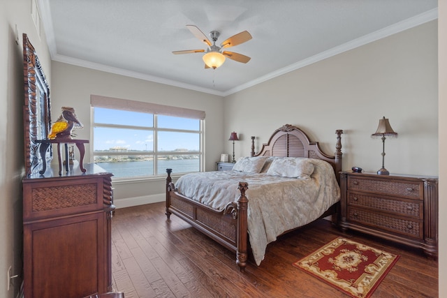 bedroom featuring dark wood-style floors, a water view, baseboards, and ornamental molding