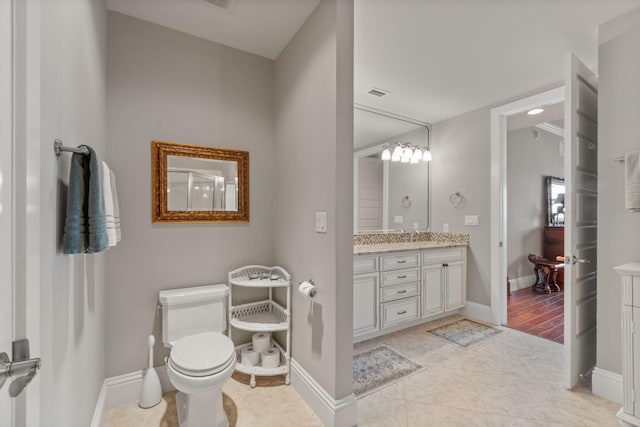 bathroom with tile patterned floors, toilet, visible vents, and baseboards