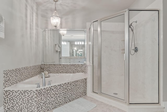 full bath featuring tile patterned floors, a chandelier, a garden tub, and a stall shower