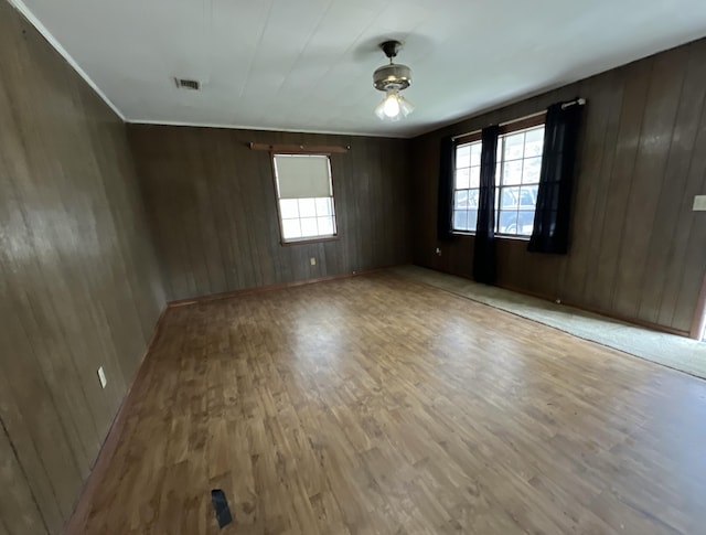 spare room featuring visible vents and wood finished floors