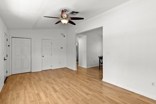 interior space with visible vents, baseboards, light wood-style floors, and a ceiling fan