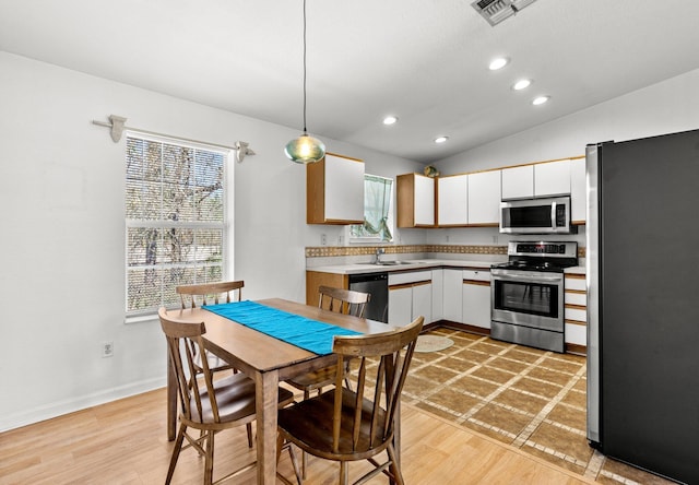 kitchen featuring a wealth of natural light, visible vents, stainless steel appliances, and light countertops