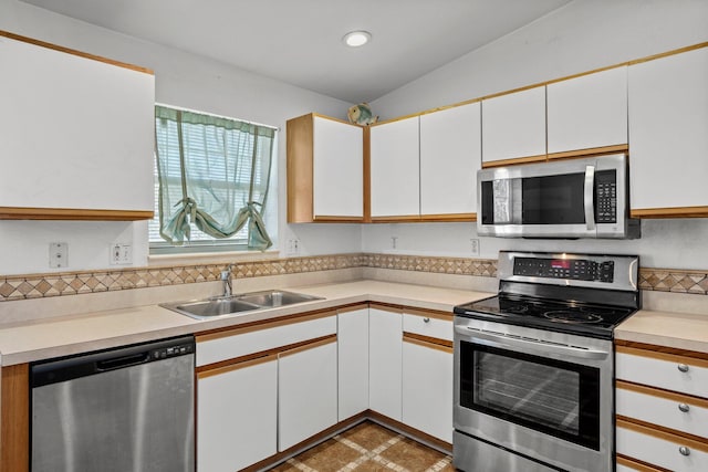 kitchen featuring white cabinetry, light countertops, appliances with stainless steel finishes, and a sink