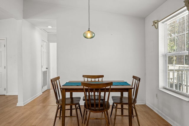 dining room featuring light wood finished floors and baseboards