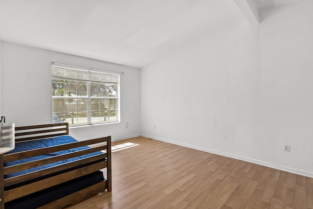 bedroom featuring baseboards and wood finished floors