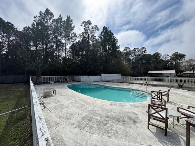 pool with a patio and fence