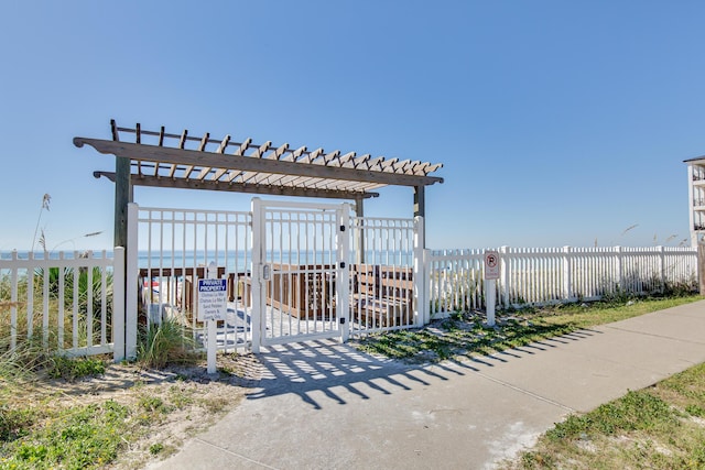 view of property's community featuring fence and a pergola