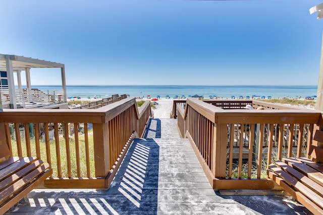 view of property's community with a beach view and a water view