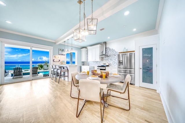 dining space with baseboards, crown molding, and light wood-style floors