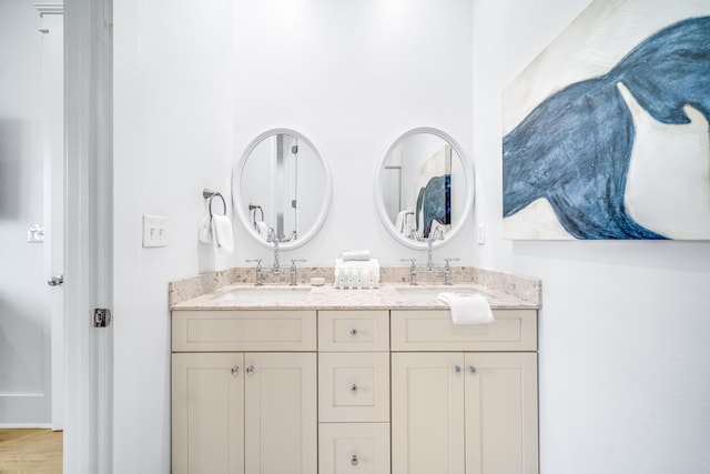 bathroom with a sink and double vanity