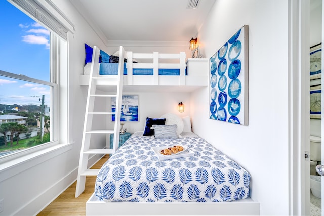 bedroom featuring visible vents, wood finished floors, and baseboards