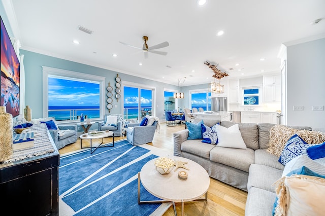 living room with crown molding, light wood-style flooring, recessed lighting, and ceiling fan