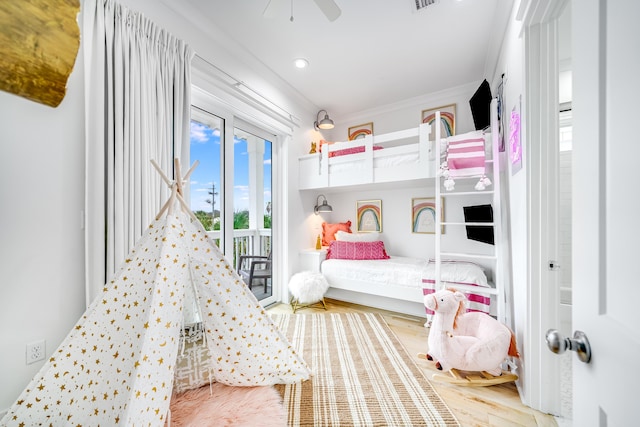 bedroom with access to exterior, visible vents, crown molding, ceiling fan, and wood finished floors