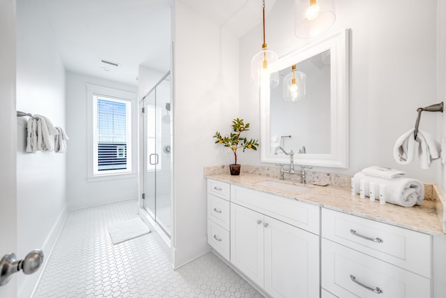 bathroom featuring baseboards, a shower stall, vanity, and tile patterned flooring