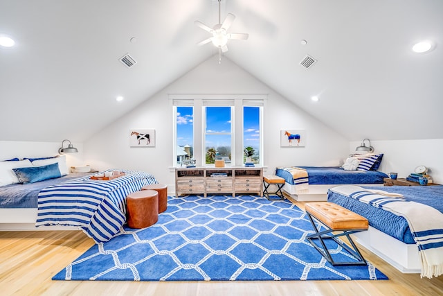 bedroom featuring visible vents, wood finished floors, and vaulted ceiling