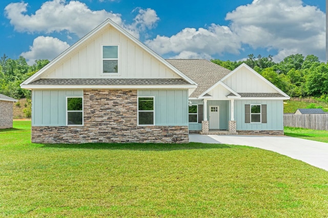 1517 Kais St, Baker, FL 32531 - craftsman-style home with fence, board and batten siding, stone siding, roof with shingles, and a front yard