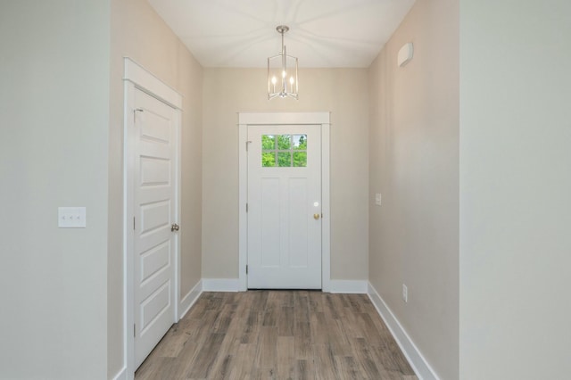 1517 Kais St, Baker, FL 32531 - foyer entrance featuring baseboards, wood finished floors, and a chandelier