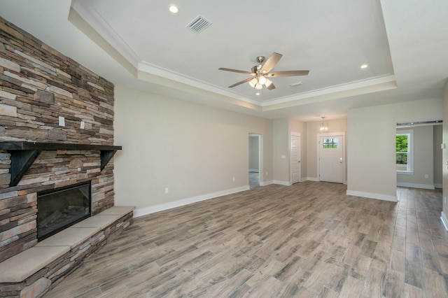 1517 Kais St, Baker, FL 32531 - unfurnished living room featuring a tray ceiling, wood finished floors, visible vents, a ceiling fan, and crown molding