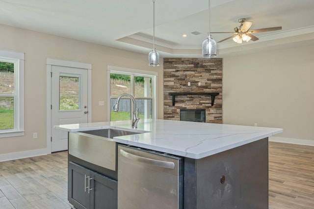 1517 Kais St, Baker, FL 32531 - kitchen with light stone counters, dishwasher, a sink, a fireplace, and light wood-style flooring