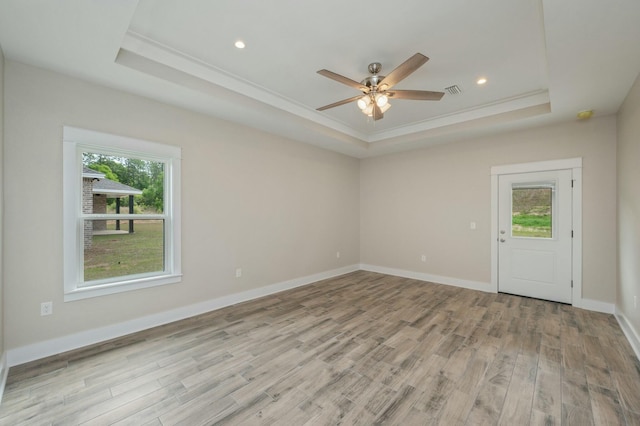 1517 Kais St, Baker, FL 32531 - spare room with light wood-type flooring, a tray ceiling, crown molding, and a healthy amount of sunlight