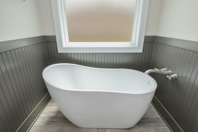 1517 Kais St, Baker, FL 32531 - bathroom featuring a soaking tub and a wainscoted wall
