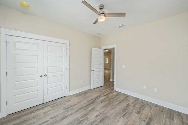 1517 Kais St, Baker, FL 32531 - unfurnished bedroom featuring light wood finished floors, visible vents, a ceiling fan, a closet, and baseboards