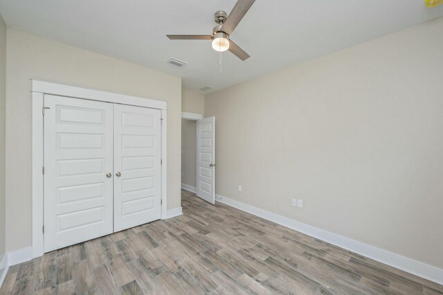 1517 Kais St, Baker, FL 32531 - unfurnished bedroom featuring visible vents, baseboards, a ceiling fan, wood finished floors, and a closet