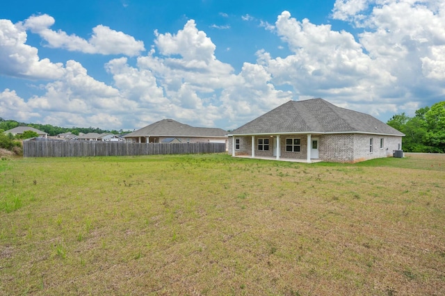 1517 Kais St, Baker, FL 32531 - rear view of house with a yard, fence, and a patio area