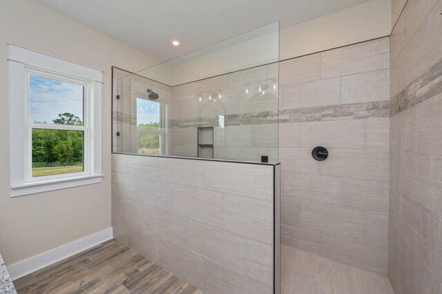 5390 Aidan St, Baker, FL 32531 - bathroom with a walk in shower, wood finished floors, and baseboards