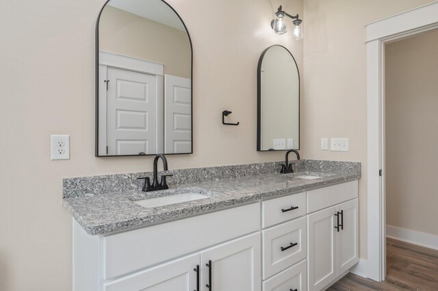 5390 Aidan St, Baker, FL 32531 - bathroom with double vanity, wood finished floors, and baseboards