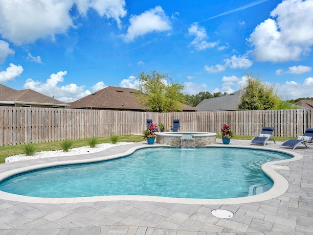 view of pool featuring a fenced backyard, a pool with connected hot tub, and a patio
