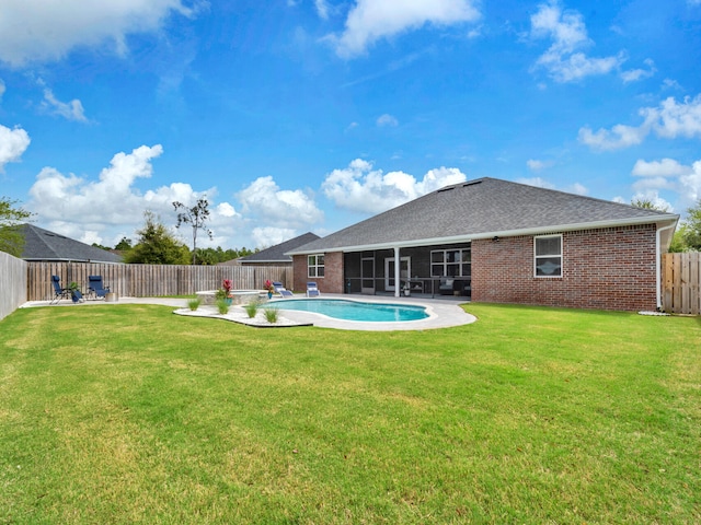 exterior space with a yard, a fenced backyard, a patio area, brick siding, and a fenced in pool