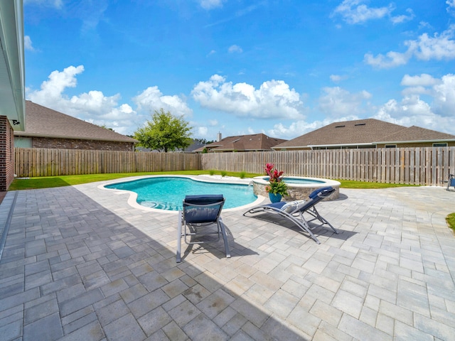 view of swimming pool with a patio area, a fenced backyard, and a pool with connected hot tub