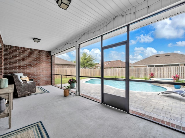 sunroom with a hot tub