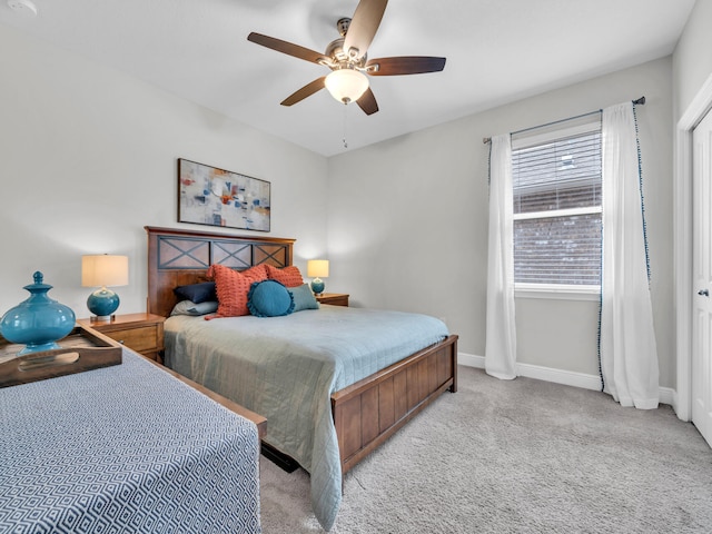 bedroom with ceiling fan, baseboards, and carpet