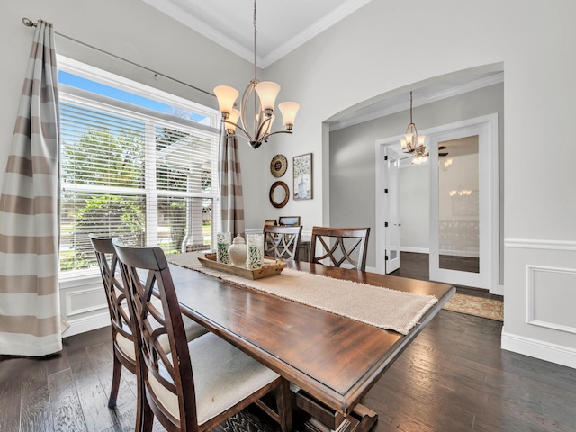 dining room featuring crown molding, an inviting chandelier, dark wood finished floors, and a wealth of natural light