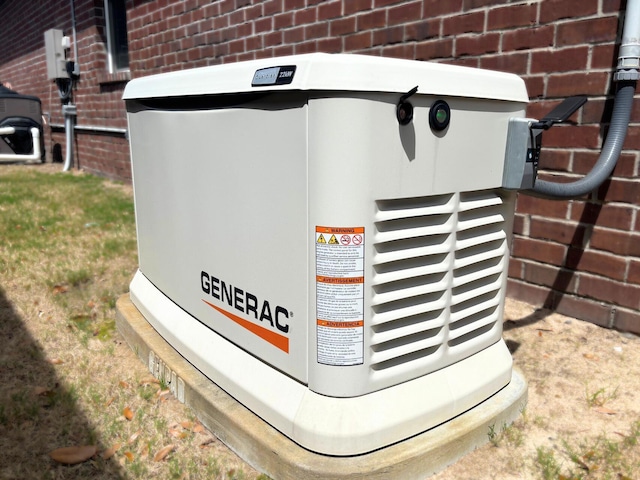 details featuring brick siding and a power unit