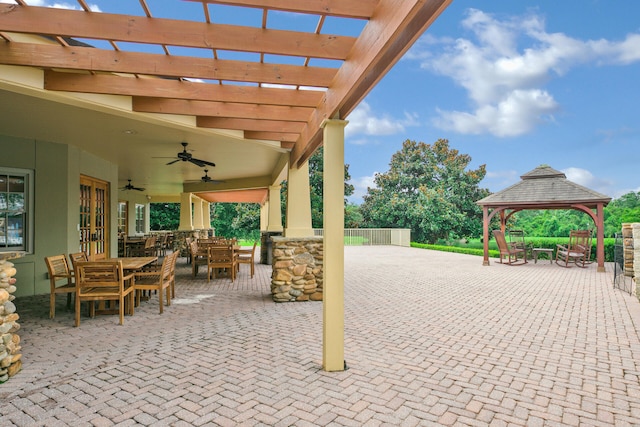 view of patio / terrace featuring outdoor dining space, a gazebo, a pergola, and a ceiling fan