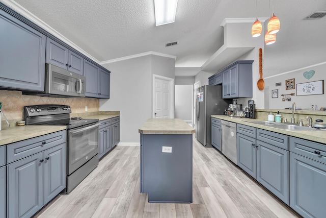 318 Peggy Dr, Crestview, FL 32536 - kitchen with visible vents, a center island, crown molding, stainless steel appliances, and a sink