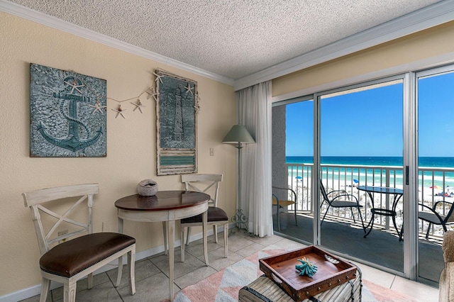 790 Santa Rosa Blvd Unit 304, Fort Walton Beach, FL 32548 - living area featuring a textured ceiling, a water view, ornamental molding, and tile patterned flooring