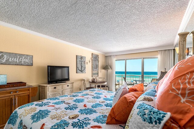 790 Santa Rosa Blvd Unit 304, Fort Walton Beach, FL 32548 - bedroom featuring access to exterior, crown molding, a textured wall, and a textured ceiling