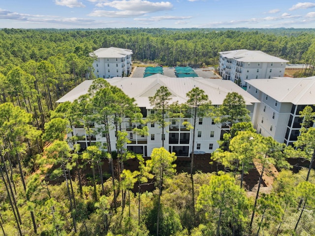 bird's eye view with a wooded view