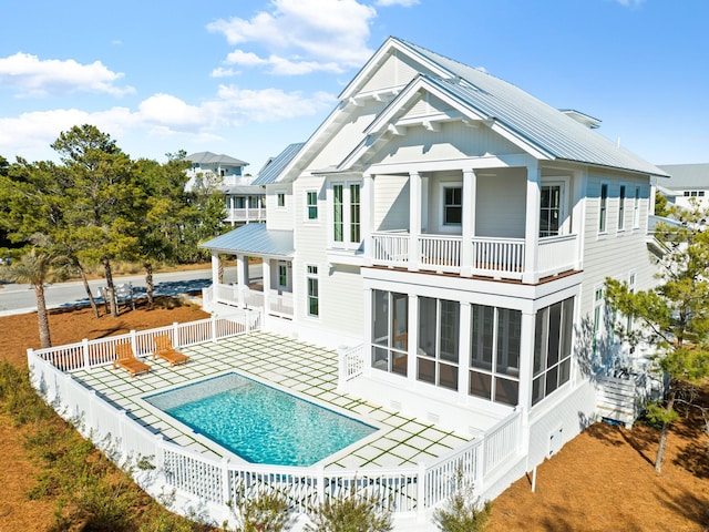 375 Morgans Trl, Santa Rosa Beach, FL 32459 - back of house featuring a balcony, metal roof, a sunroom, and fence