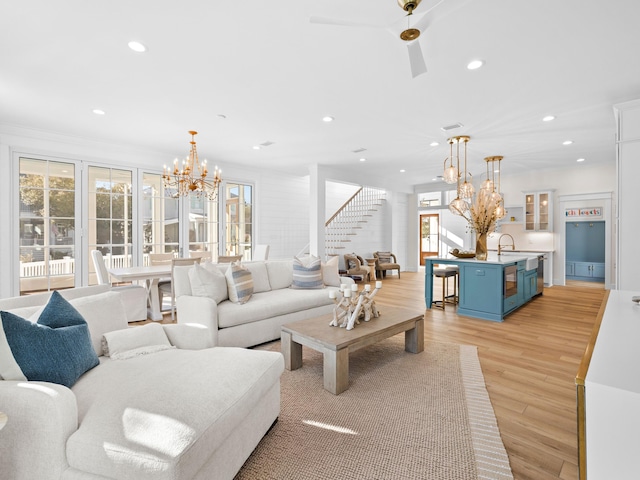 375 Morgans Trl, Santa Rosa Beach, FL 32459 - living room with stairs, light wood-style floors, recessed lighting, and an inviting chandelier