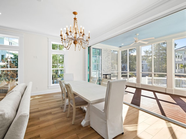 375 Morgans Trl, Santa Rosa Beach, FL 32459 - dining space with baseboards, ceiling fan with notable chandelier, crown molding, and hardwood / wood-style flooring
