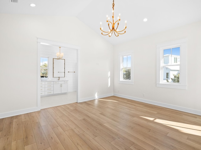 375 Morgans Trl, Santa Rosa Beach, FL 32459 - empty room featuring vaulted ceiling, baseboards, light wood-style floors, and a chandelier