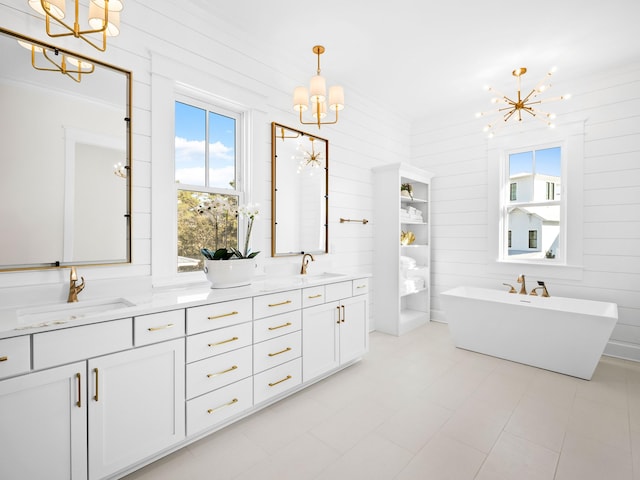 375 Morgans Trl, Santa Rosa Beach, FL 32459 - bathroom featuring double vanity, a sink, an inviting chandelier, and a freestanding bath