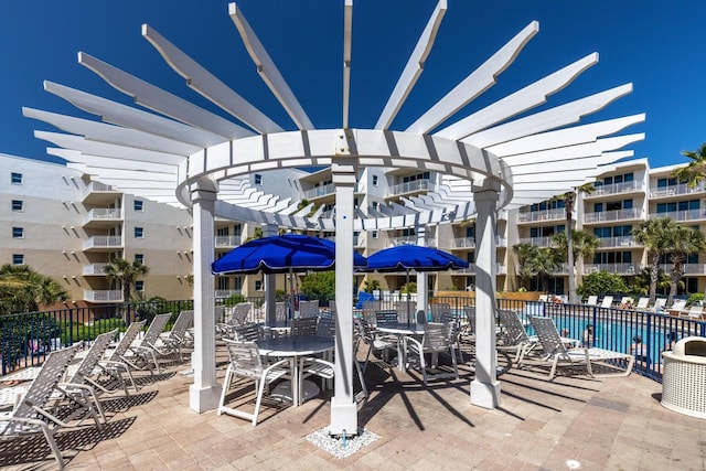 view of patio with a pergola and fence