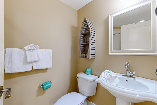 bathroom featuring toilet and a sink