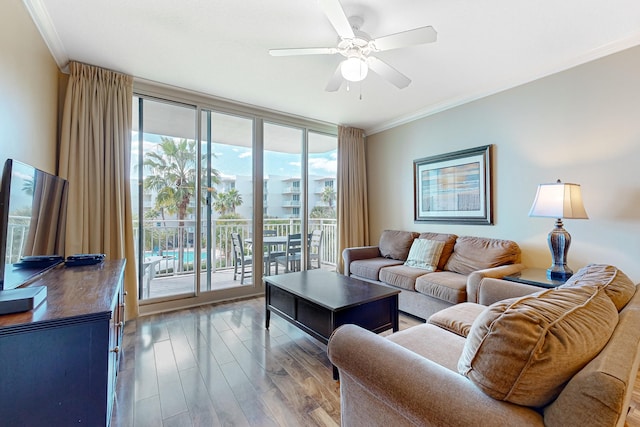 living room featuring floor to ceiling windows, a ceiling fan, ornamental molding, and wood finished floors